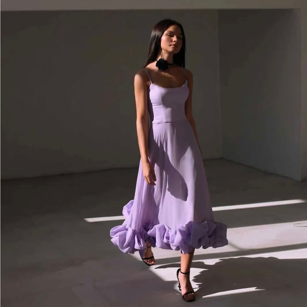 Lilac Flared Spaghetti Strap Dress With Ruffle Hem On Bottom.
